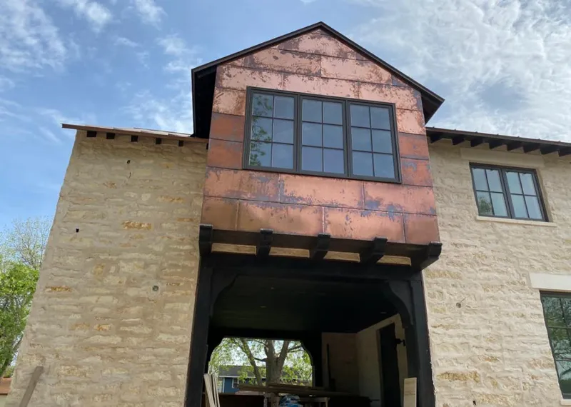 Copper metal panel facade on a stone building for Skylight Installation in Lake Elmo